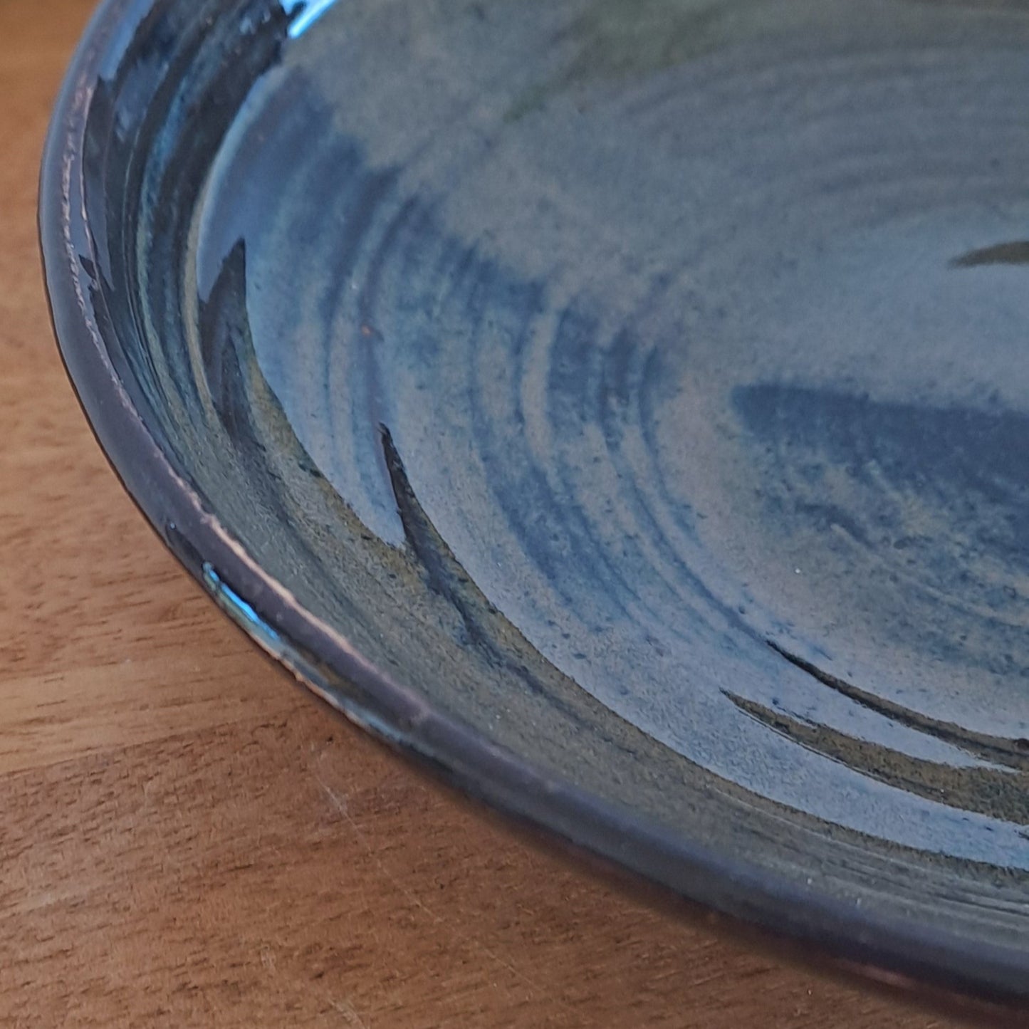 Close-up of a black bowl on a wooden surface