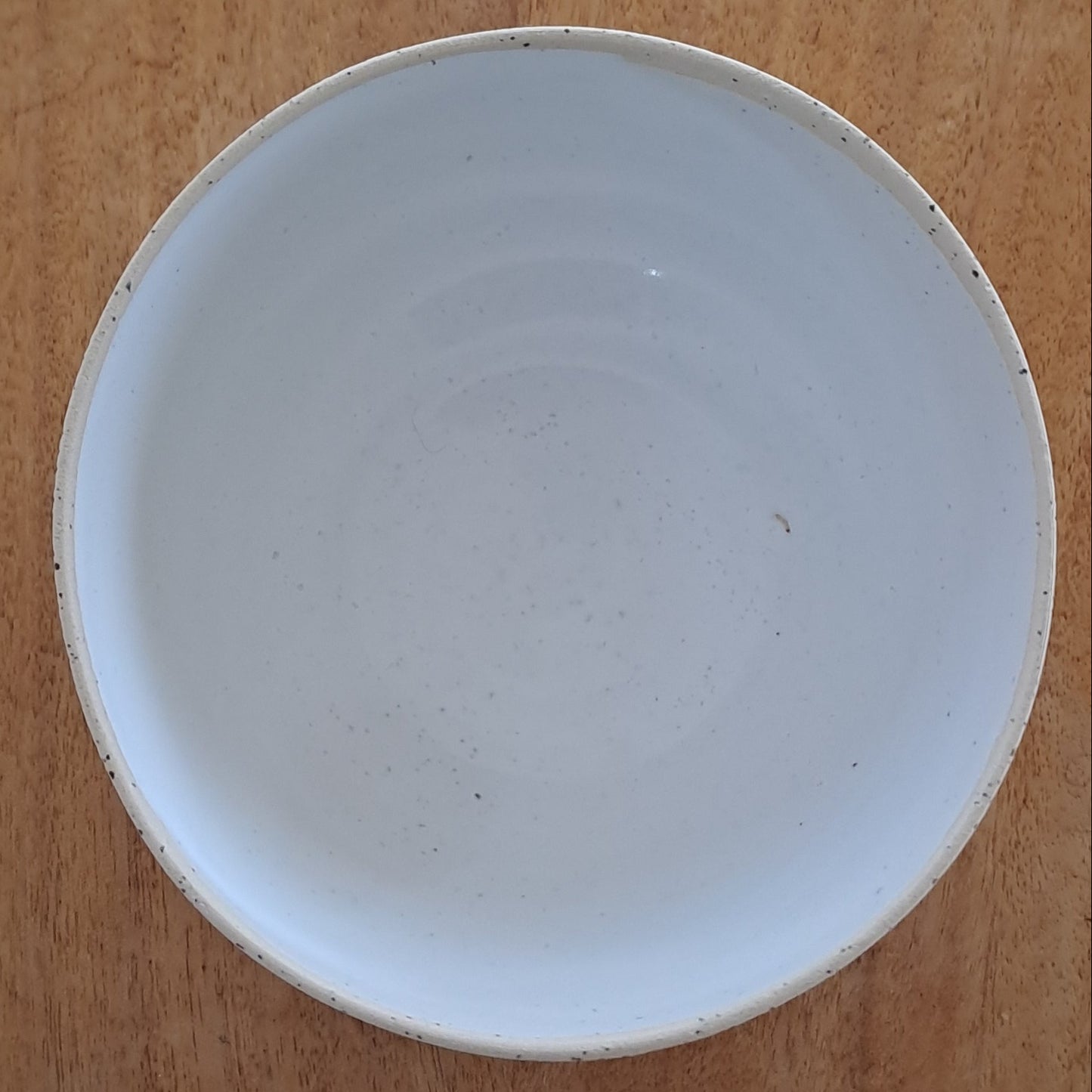 White ceramic plate on a wooden stand