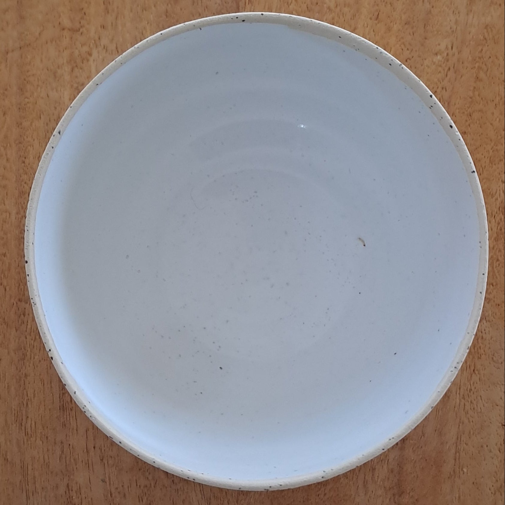 White ceramic plate on a wooden stand