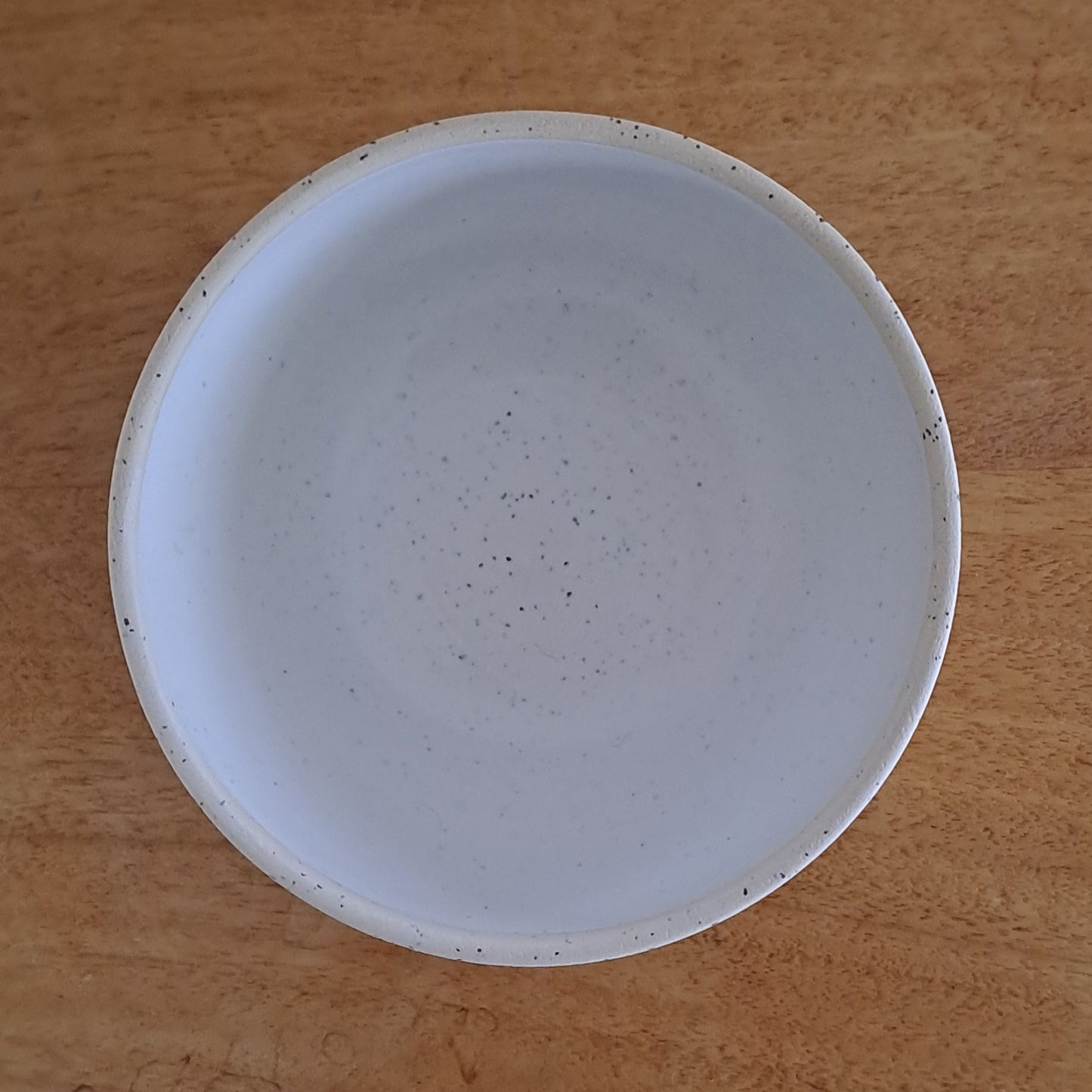 White ceramic bowl on a wooden surface 