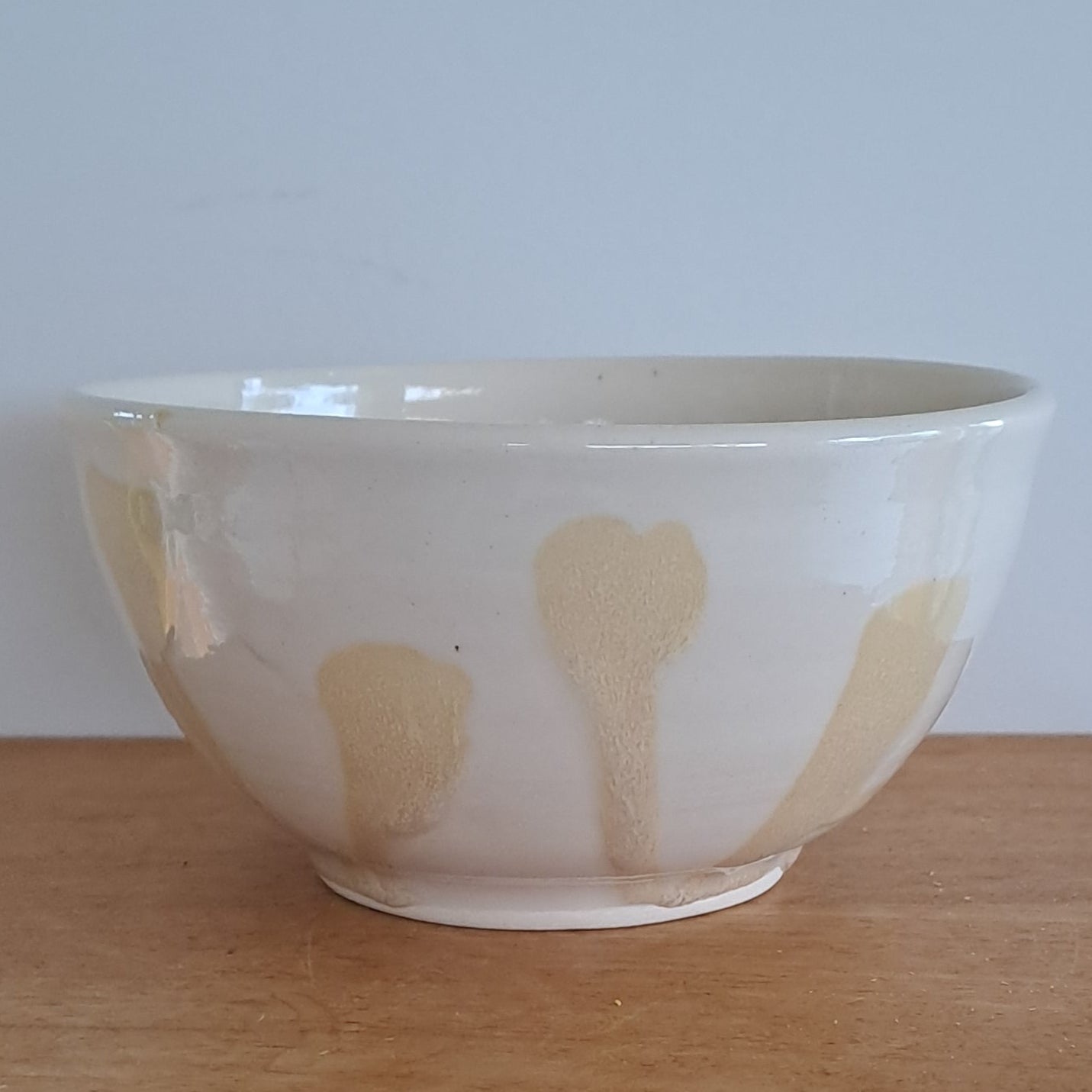 Ceramic bowl with floral design on a wooden surface