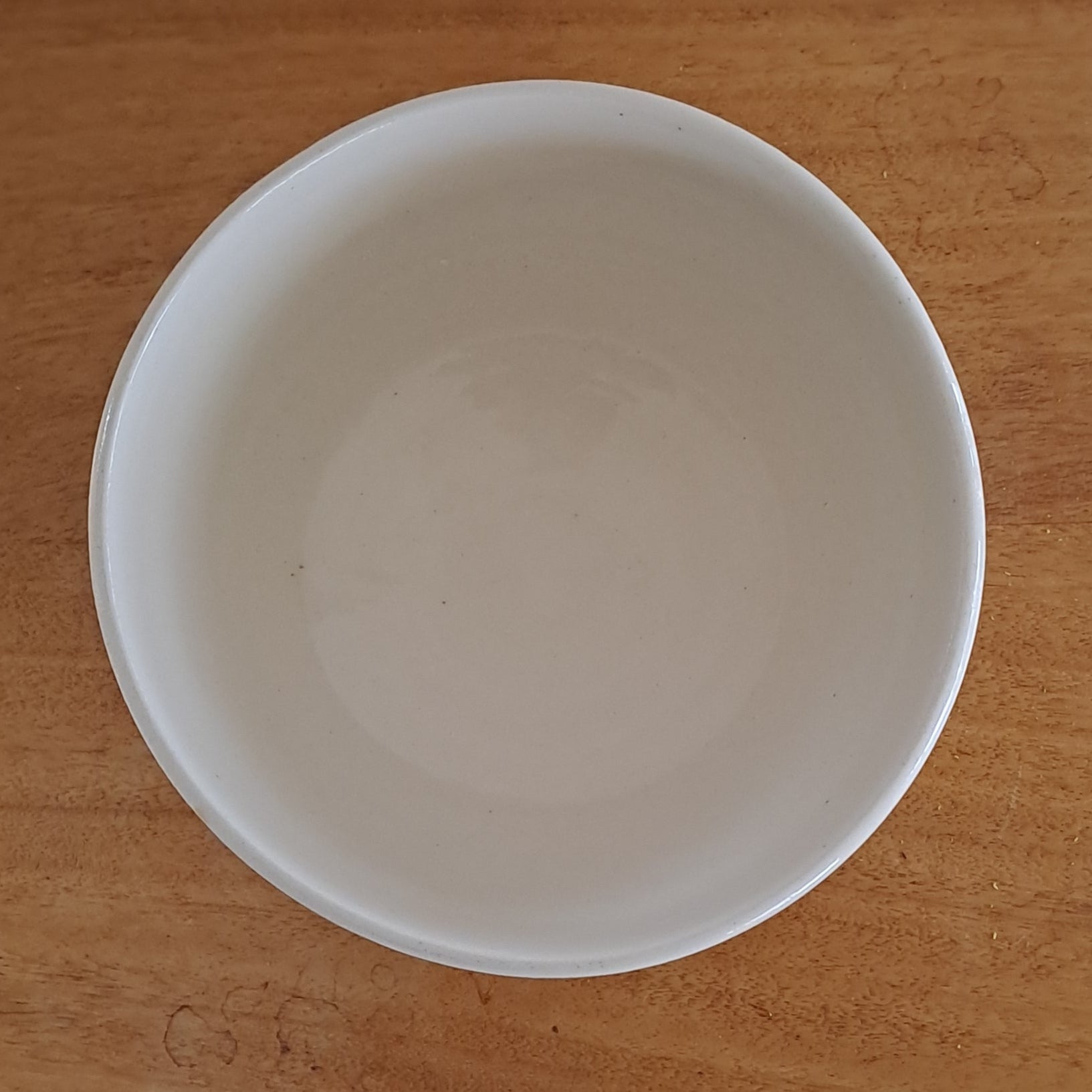 White bowl on a wooden surface