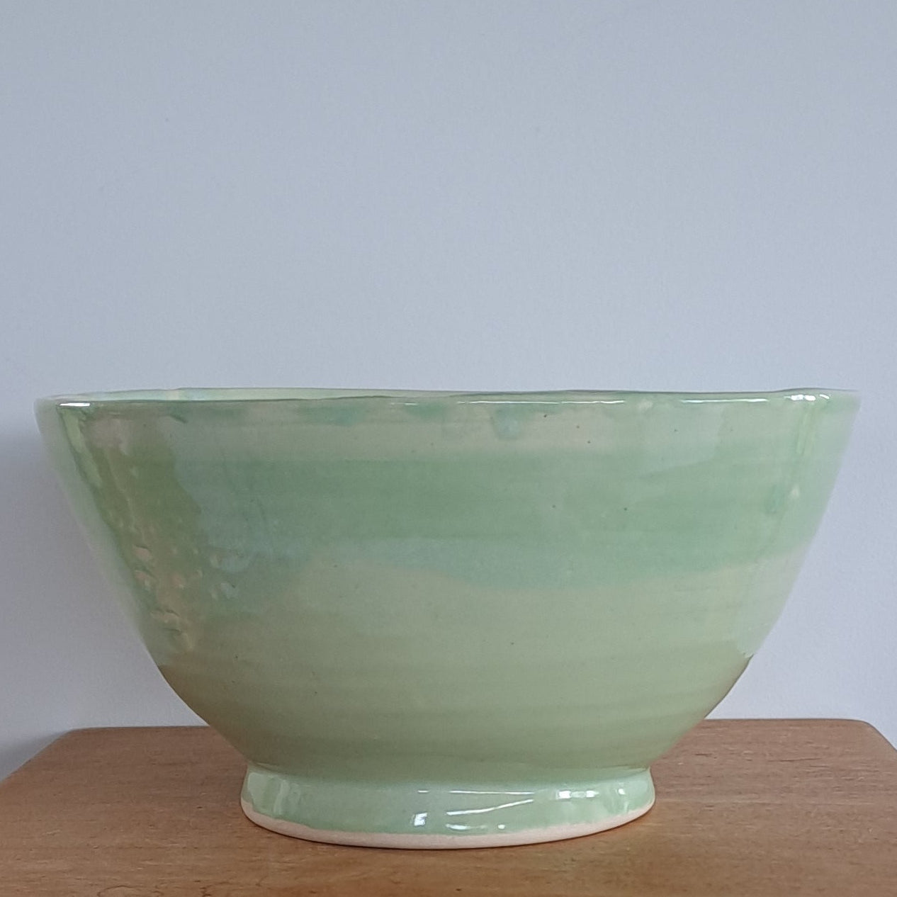 green ceramic bowl on a light gray background