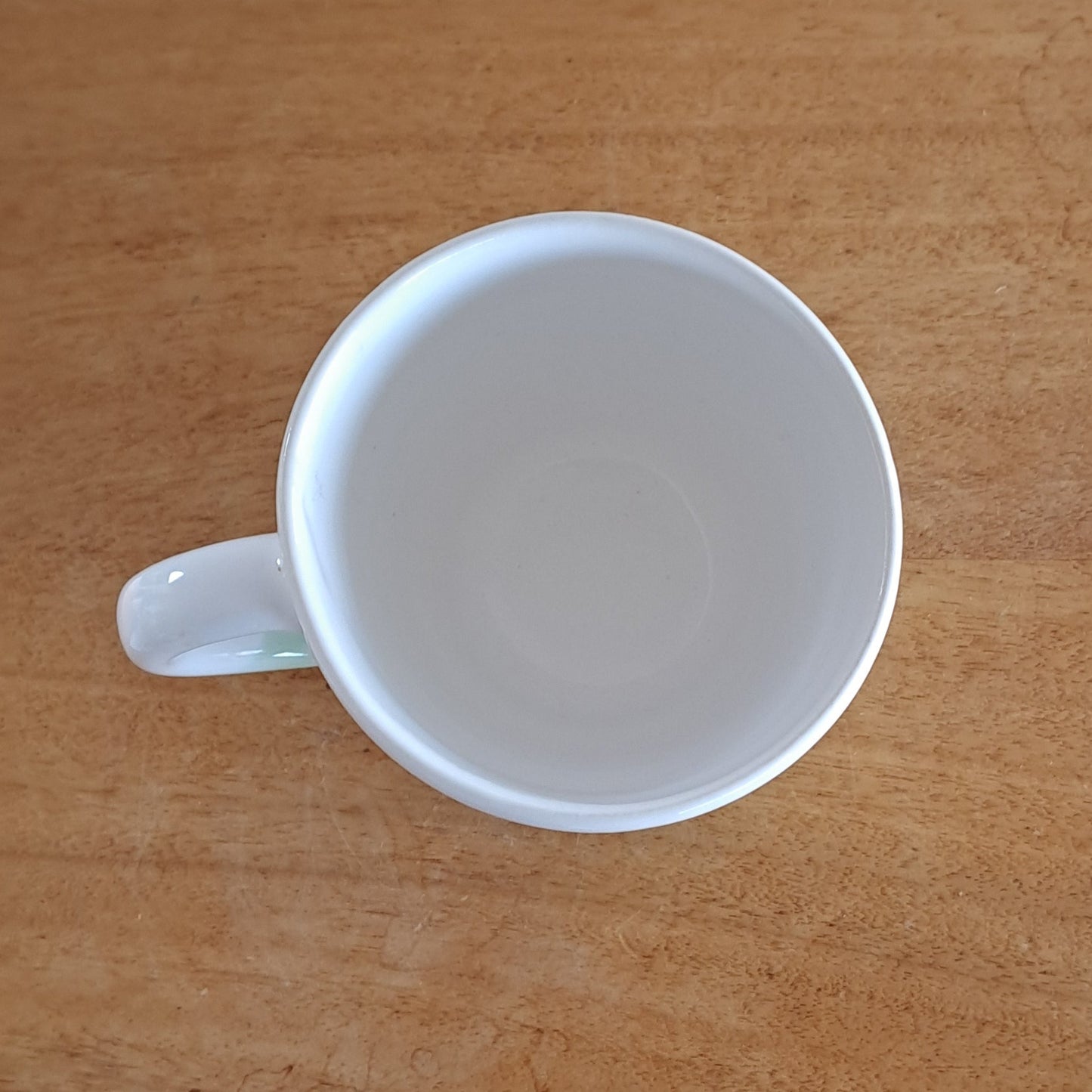 White mug on a wooden surface