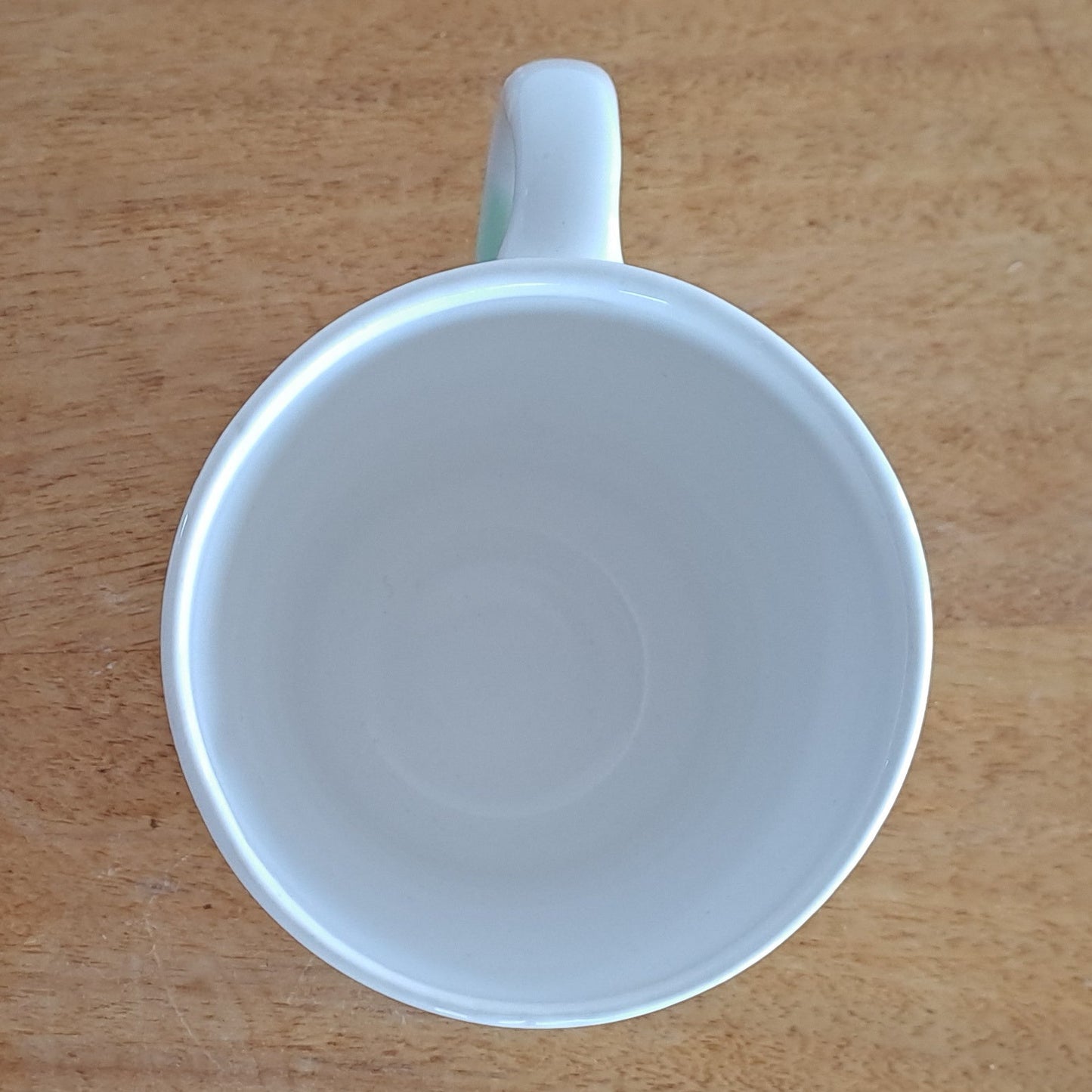White ceramic cup on a wooden stand
