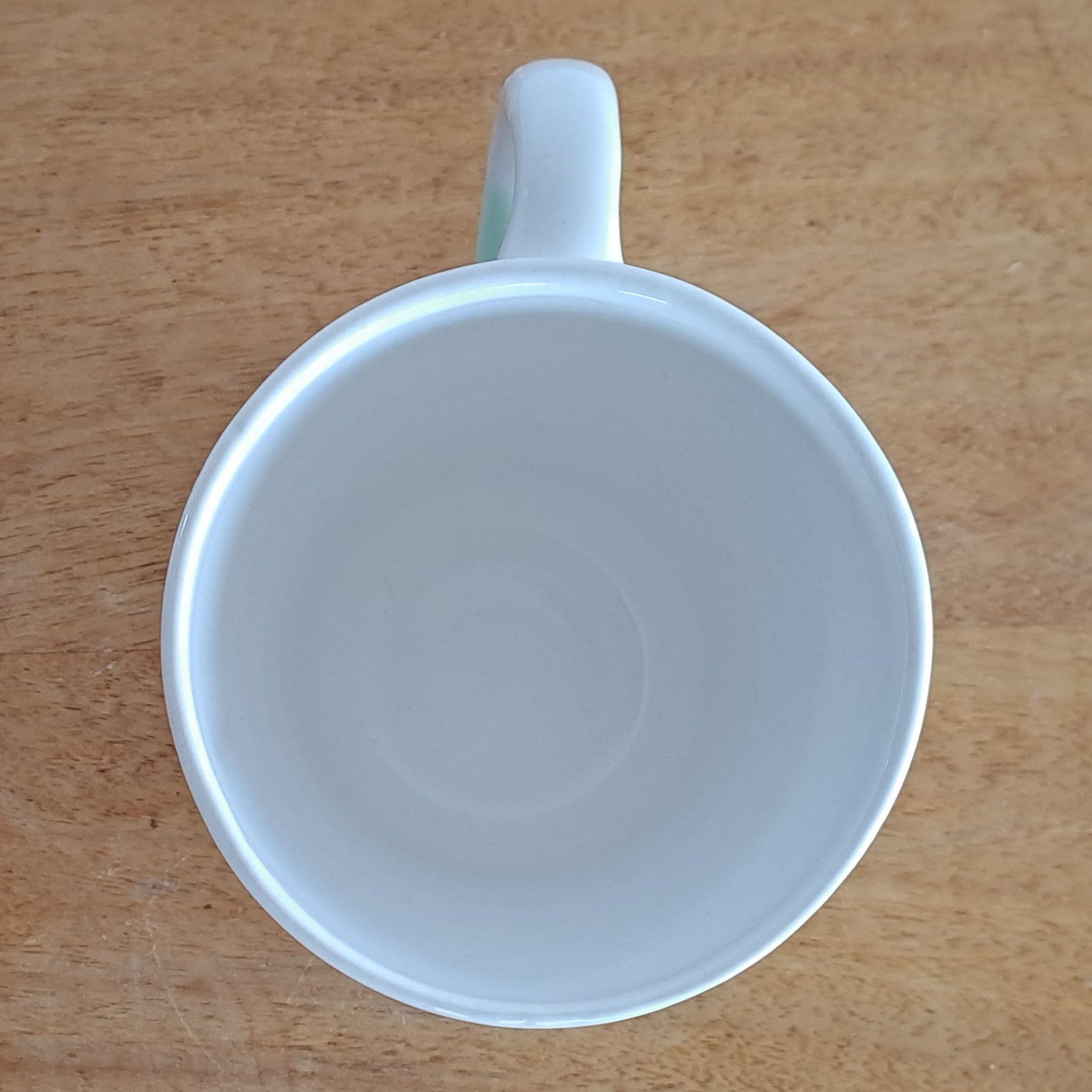 White ceramic cup on a wooden stand