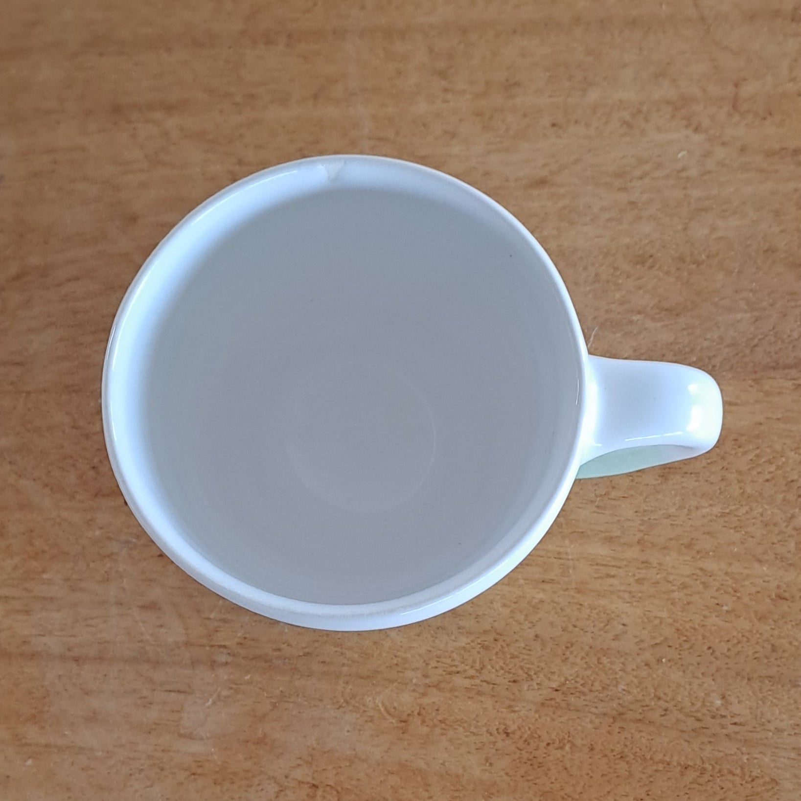 White mug on a wooden surface