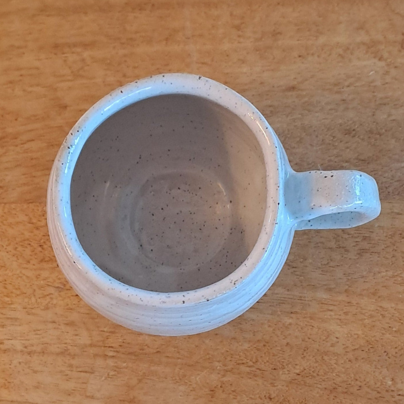 Round mug on a wooden surface 