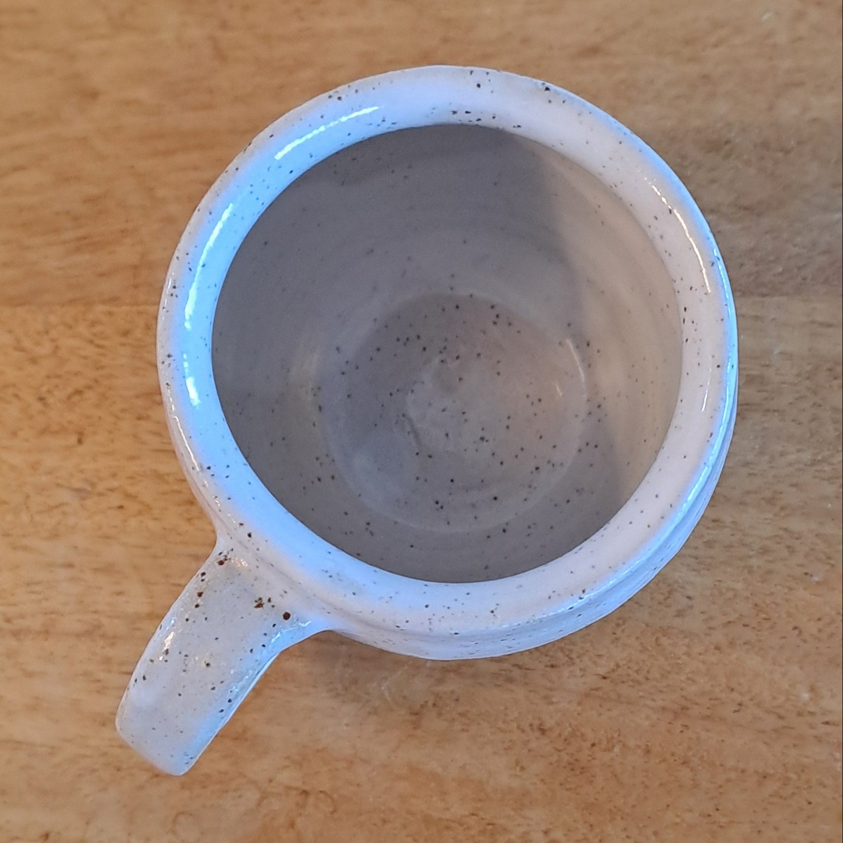 White ceramic mug on a wooden surface