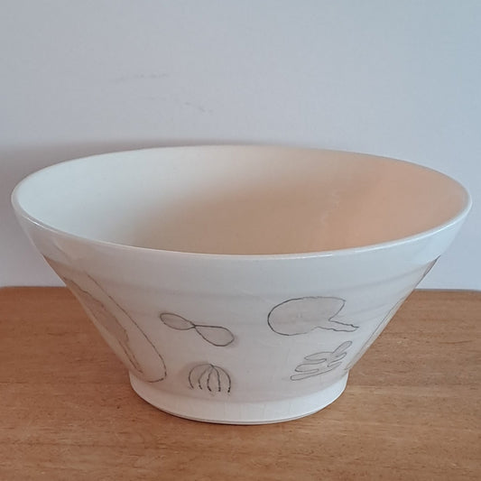 White bowl with simple design on a wooden surface