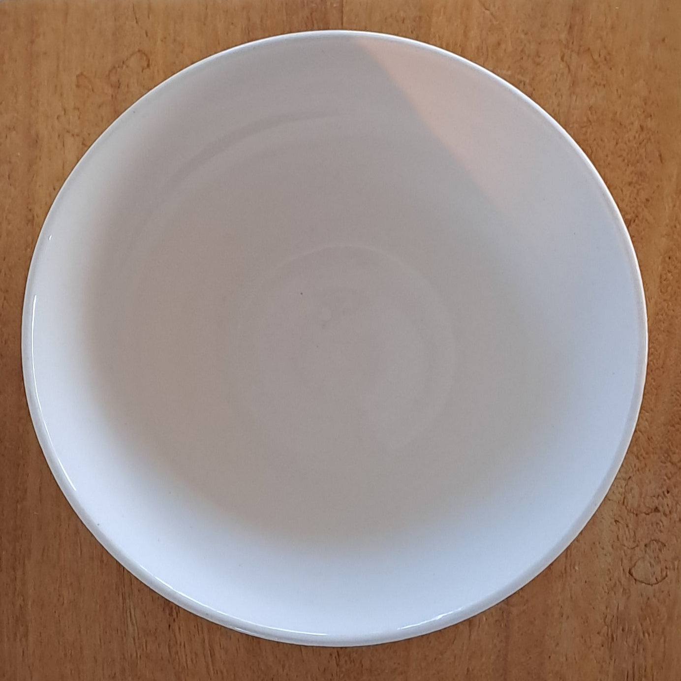 White ceramic bowl on a wooden stand