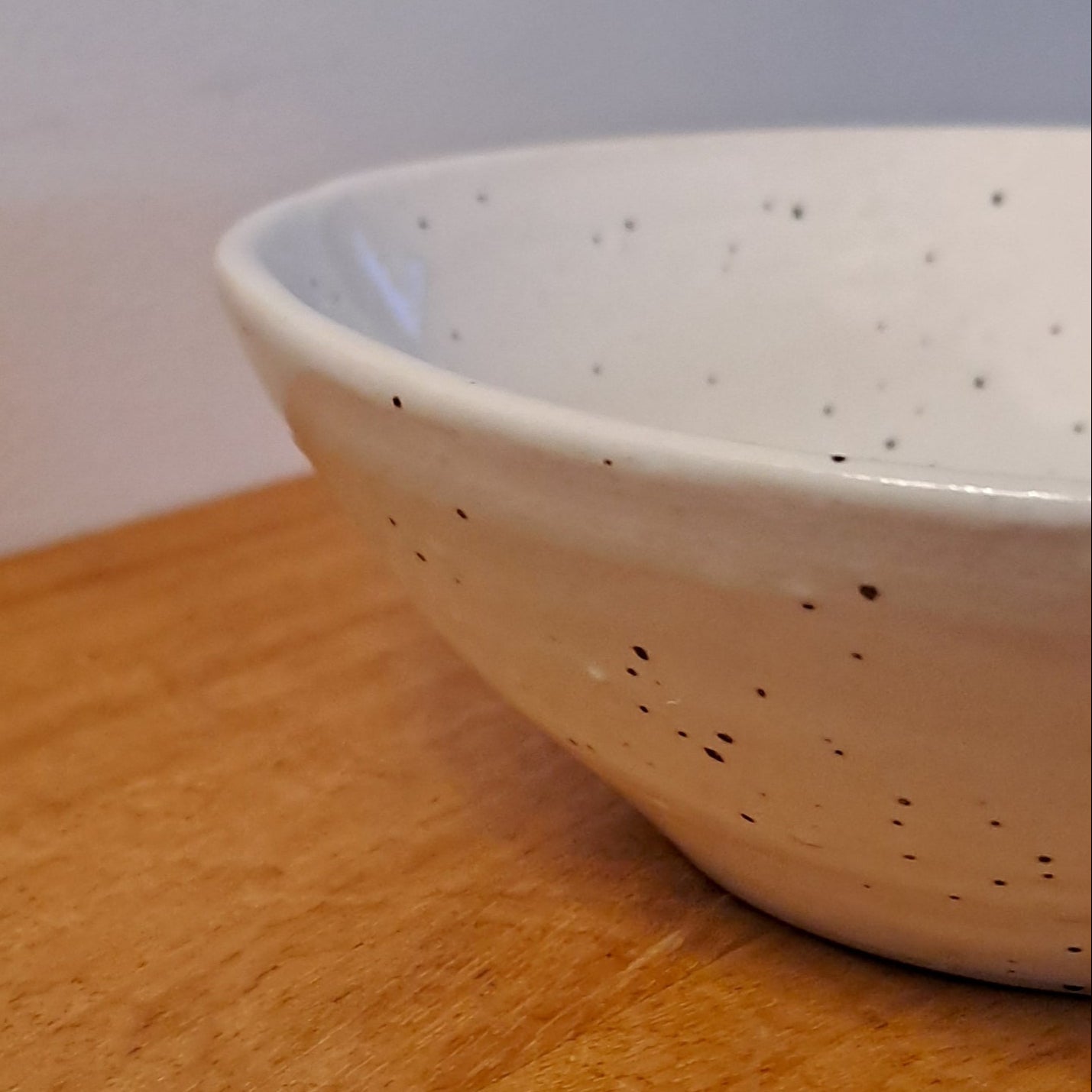 White ceramic bowl on a wooden surface