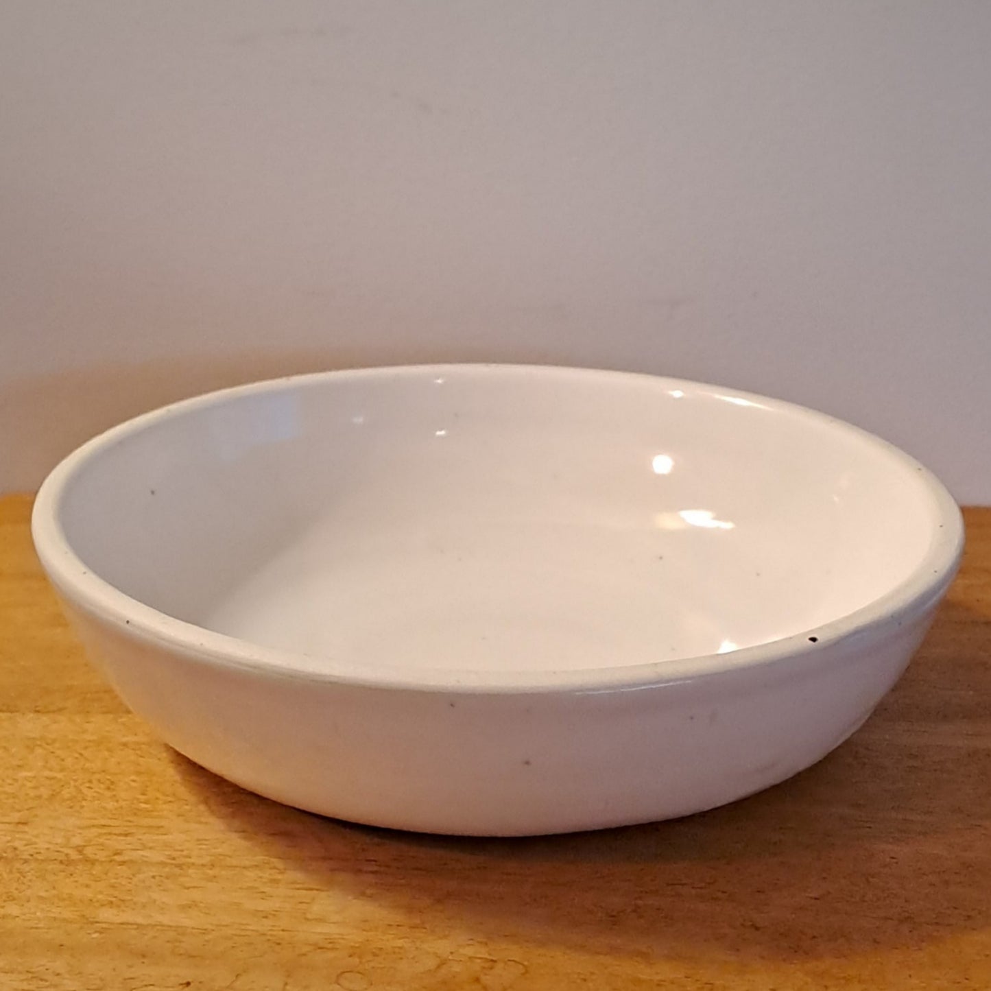 White bowl on a wooden surface