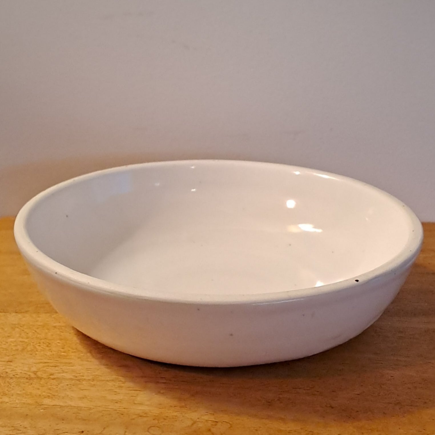 White bowl on a wooden surface