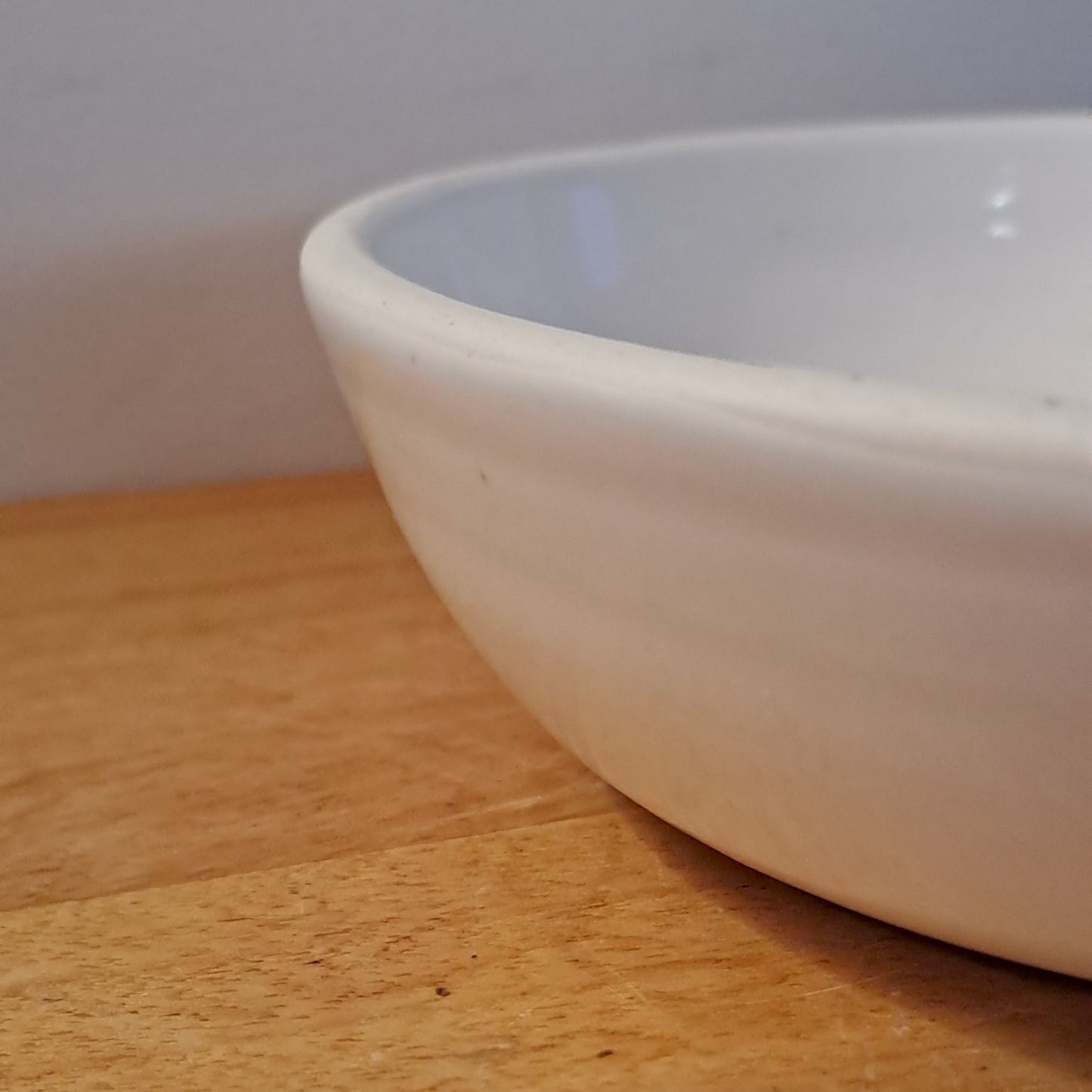 White bowl on a wooden surface