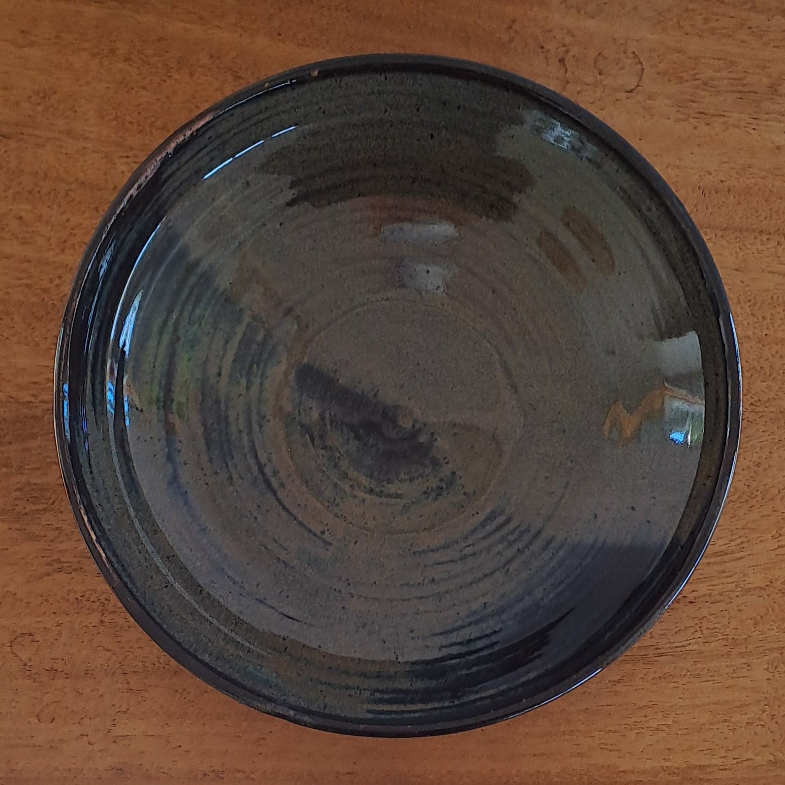 everyday bowl is crafted from speckled stoneware and finished with a tenmoku glaze