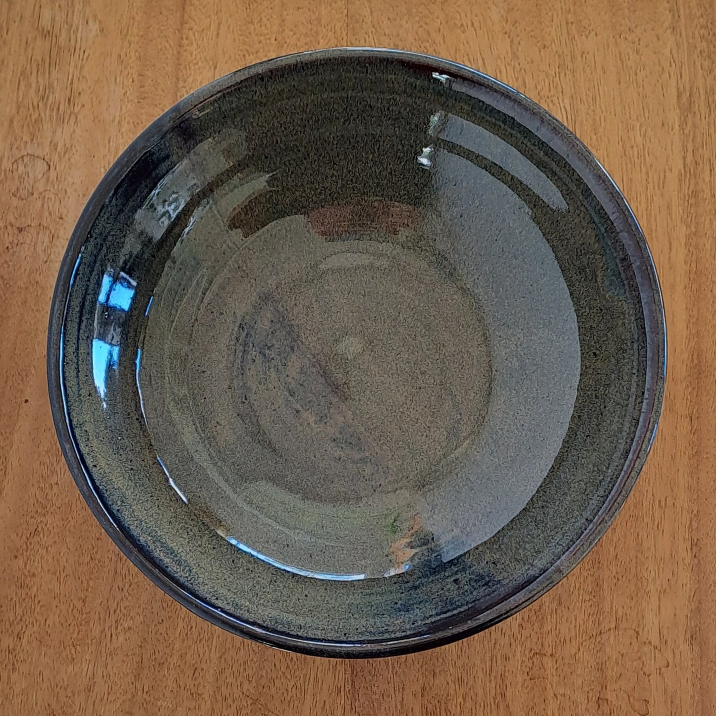 everyday bowl is crafted from speckled stoneware and finished with a tenmoku glaze