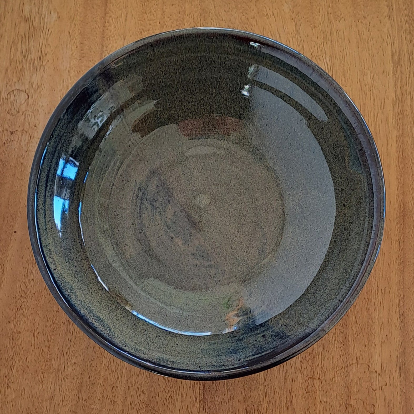 everyday bowl is crafted from speckled stoneware and finished with a tenmoku glaze